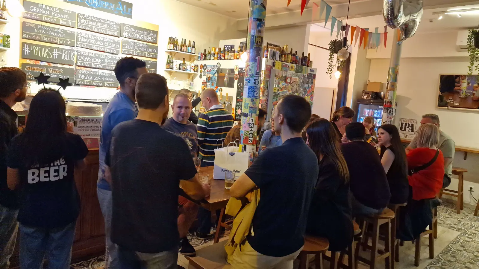 Pessoas a desfrutar de cervejas artesanais no Queen Ale em Arroios