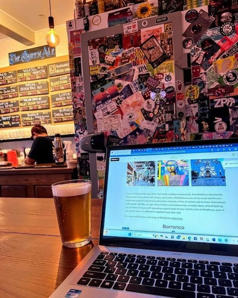 Laptop and craft beer on a table inside Queen Ale in Arroios, Lisbon